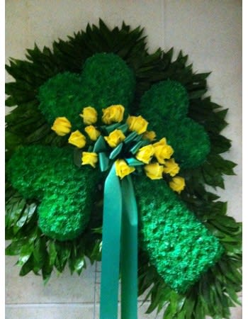 Green floral wreath with yellow roses and a teal ribbon