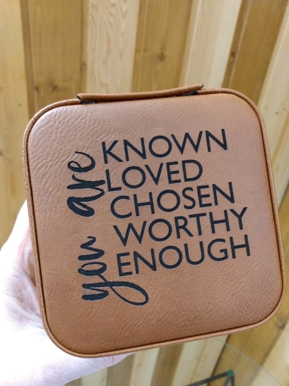 Tan square gift box with the words "known loved chosen worthy enough"