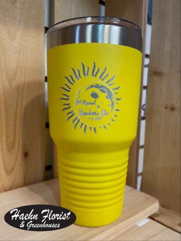Yellow insulated tumbler with a silver lid and printed sun design