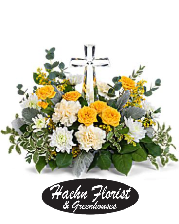 Yellow and white flower arrangement with a clear cross centerpiece