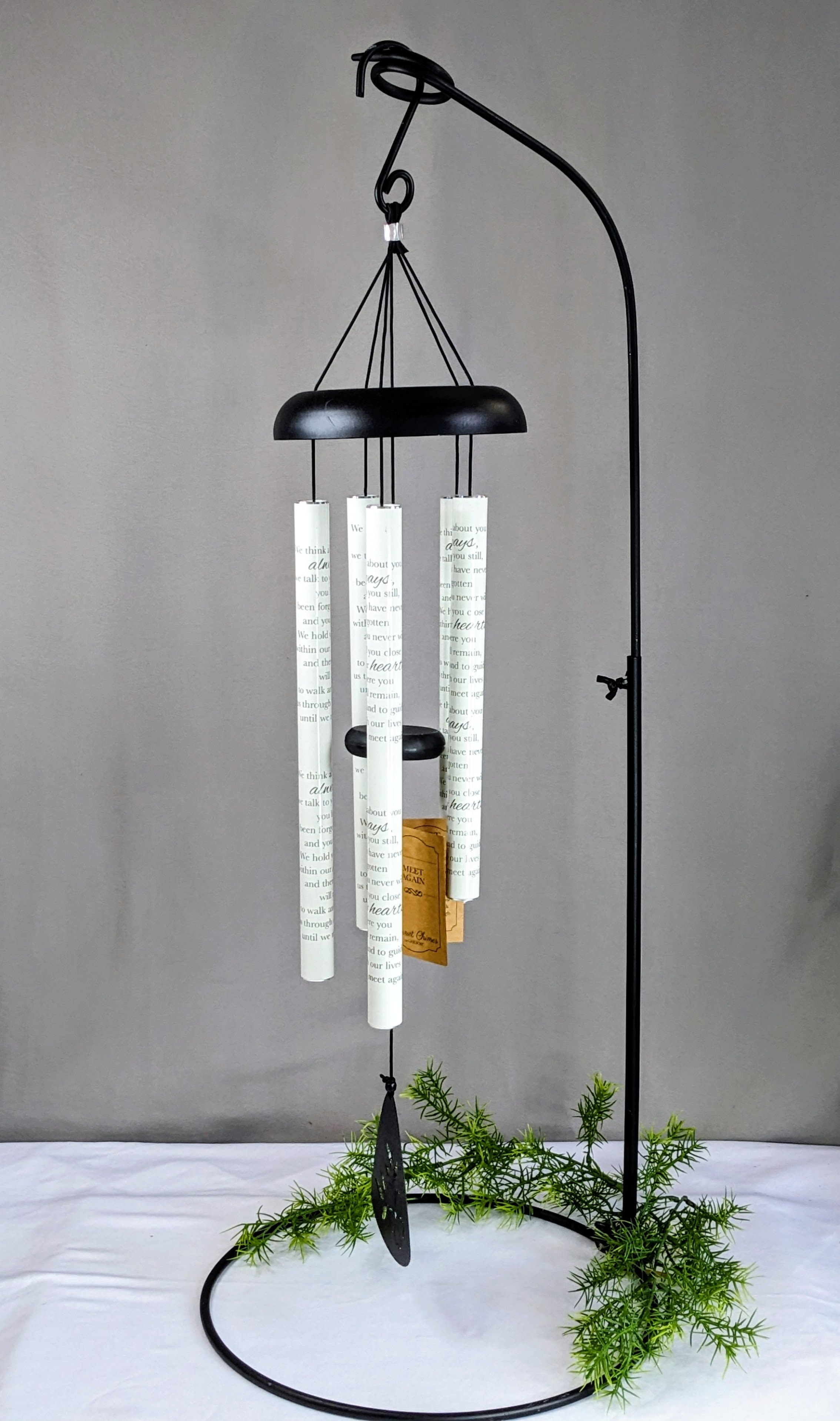 Traditional Wind Chime - 3 Size Options - Wind chimes make a meaningful and lasting gift for any occasion. Designed and tested to withstand outdoor elements, these beautiful chimes create soothing, melodic tones as the breeze gently moves through them. Their peaceful sound brings comfort, remembrance, and joy to any outdoor space.  We offer a variety of touching phrases and sentiments on our chimes. Please call the shop for current phrase availability.  Each set of chimes is thoughtfully dressed for the occasion with vibrant ribbon and, upon request, life-like silk flowers to add a special decorative touch.  The stand shown with the chimes is a rental piece, and the price of the chimes includes the stand rental for display.  We carry three sizes of chimes: Small, Medium, and Large. Measurements are taken from the top of the hook to the very bottom of the sail.  PHOTOS SHOWN ARE FOR EXAMPLE PURPOSES ONLY Small - 30" Medium -38" Large - 48"   ******* All Chimes are specific to our shop. If you're looking for these to be delivered outside of our standard delivery area, please call before placing your order. Not all shops carry wind chimes. Thank You. ******* 
