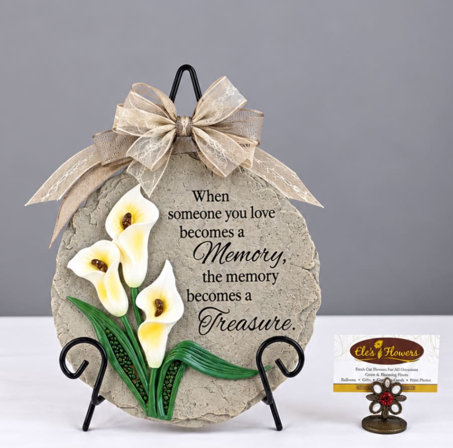 Decorative memorial plaque with white calla lilies and a ribbon bow