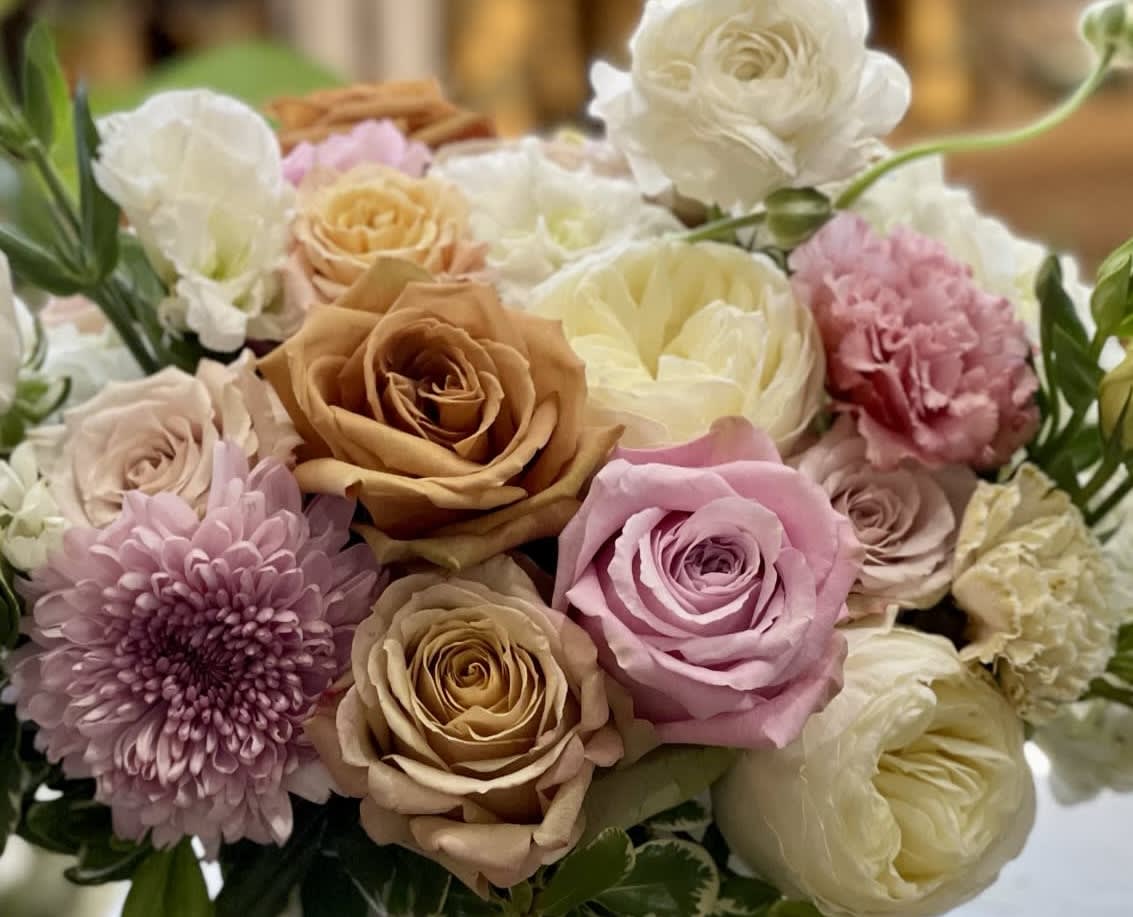 Mixed bouquet of blush, peach, and cream roses with chrysanthemums and carnations