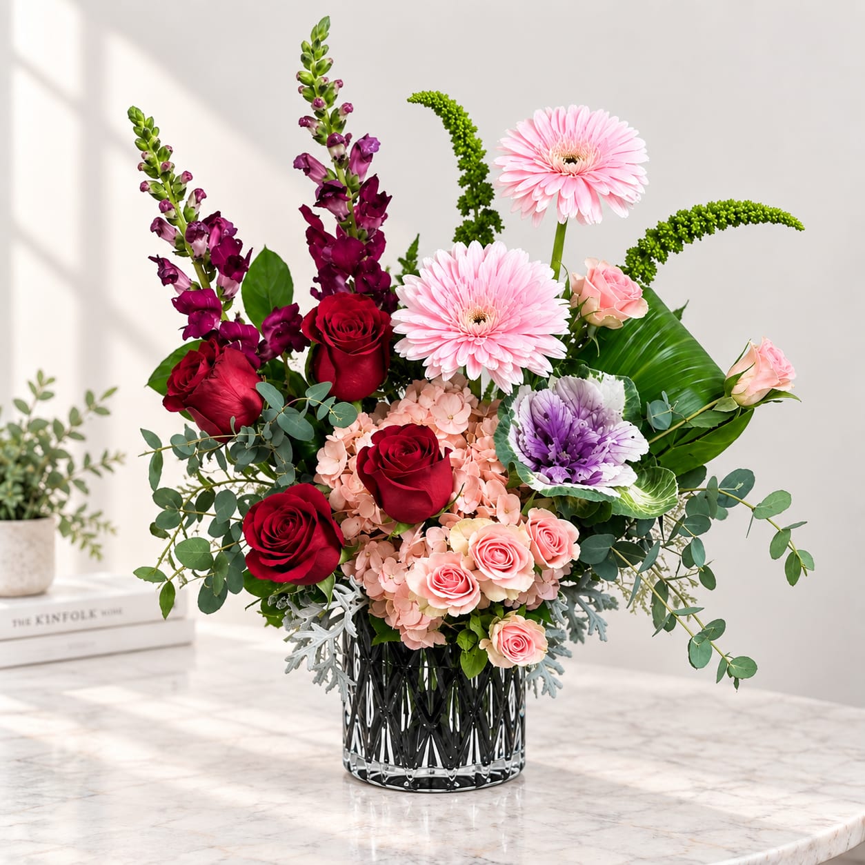Mixed bouquet in a glass vase with roses, gerbera daisies, and purple blooms