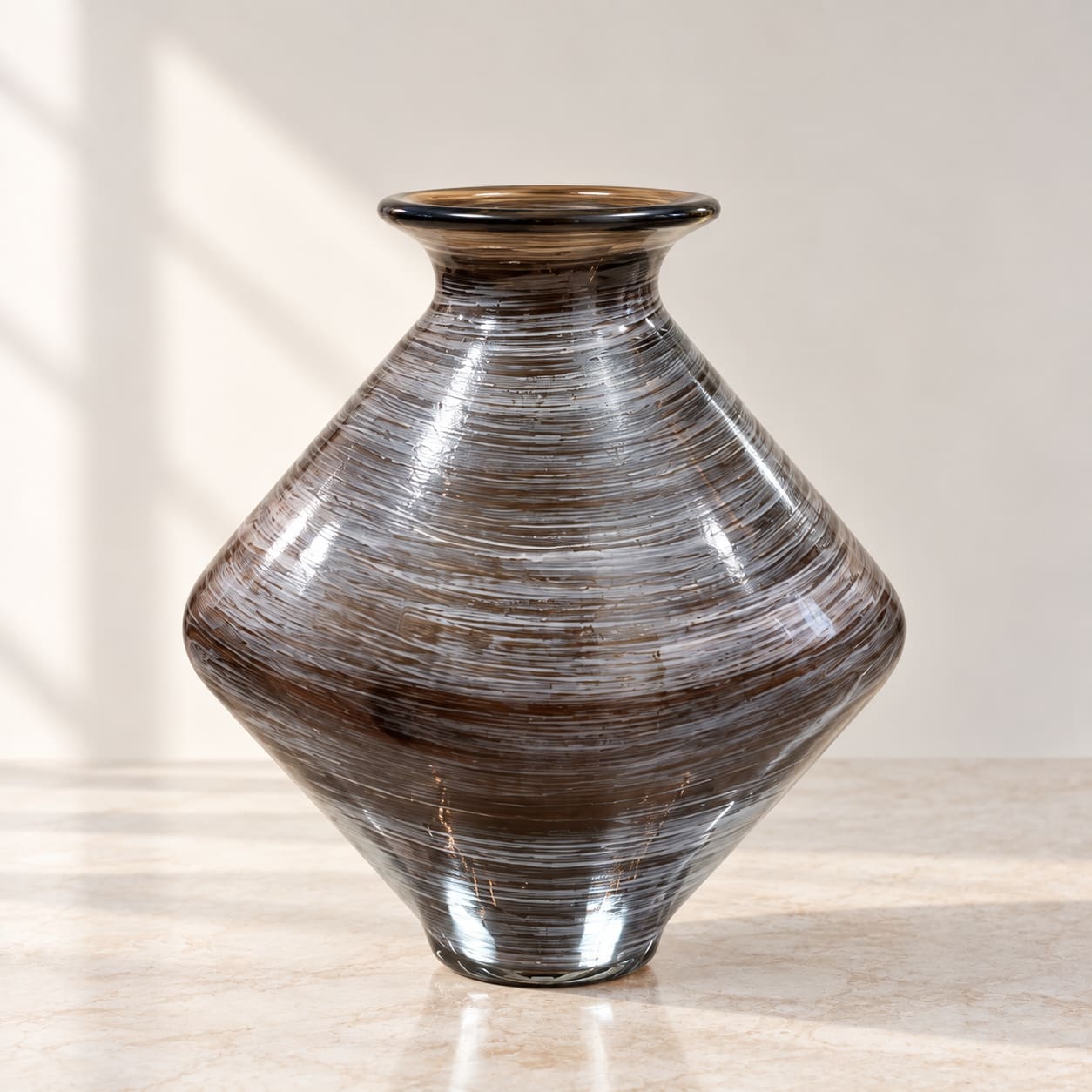 Brown striped glass vase on a light surface
