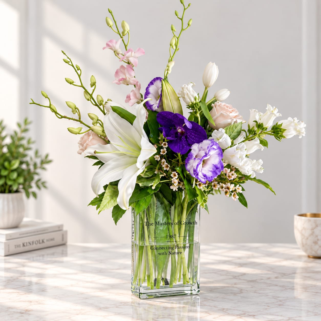 Mixed bouquet of lilies, orchids, and roses in a clear glass vase