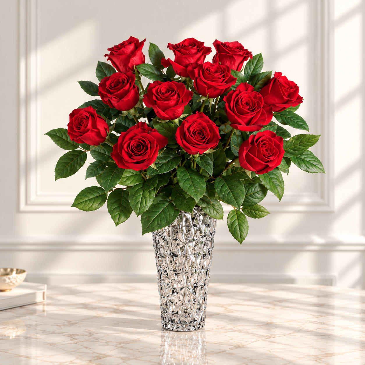Red roses arranged in a silver textured vase