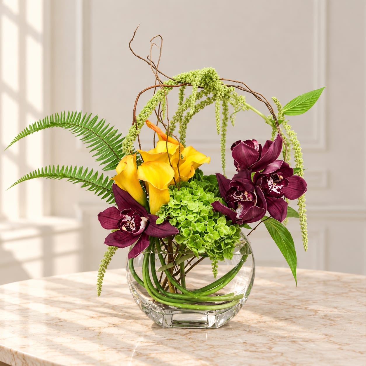 Yellow calla lilies and purple orchids in a clear glass vase