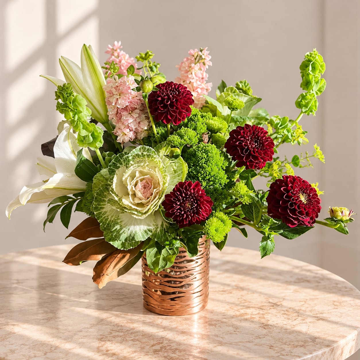 Mixed floral arrangement in a copper vase with white lilies and burgundy blooms