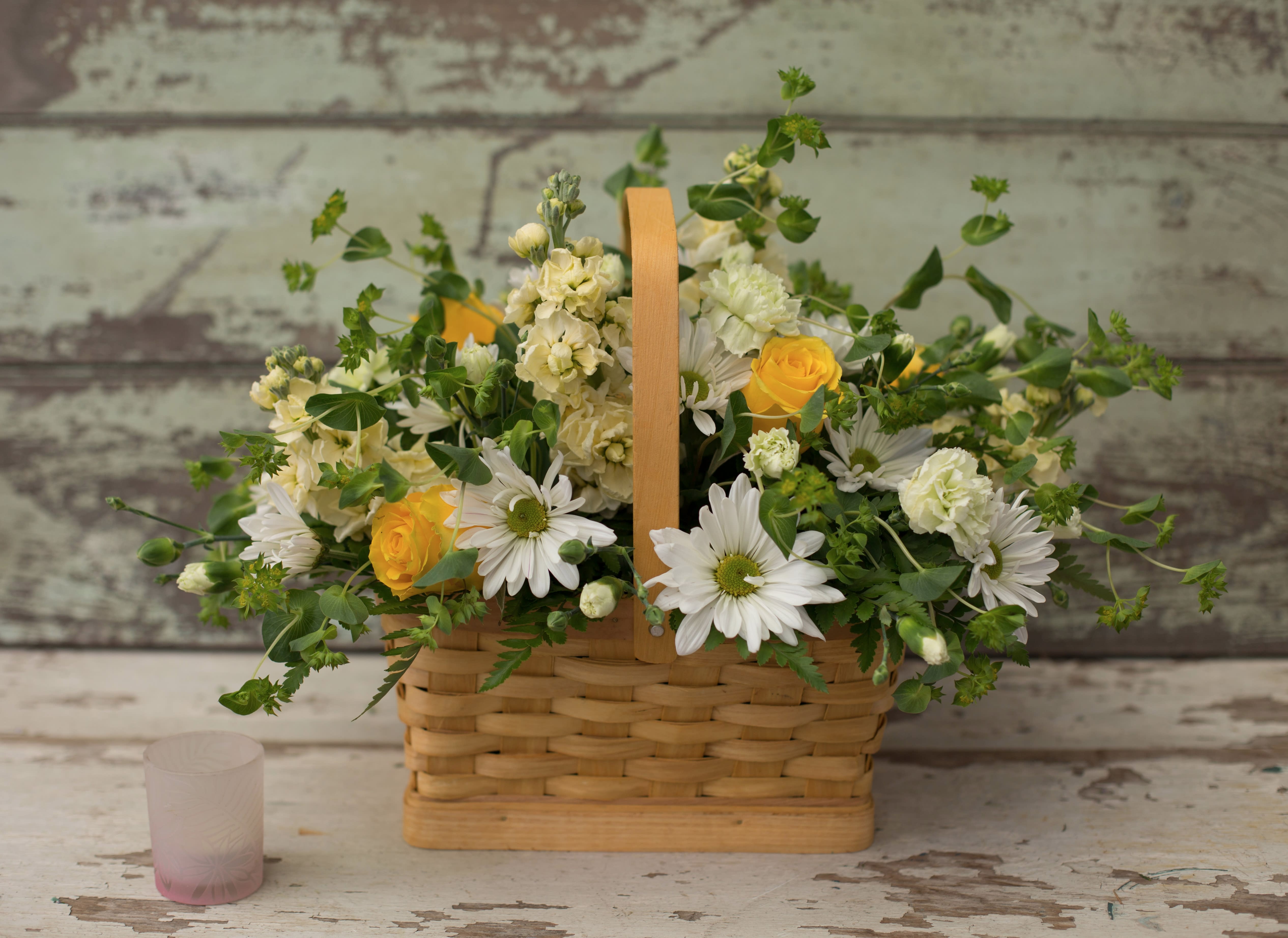 Basket arrangement with white daisies and yellow roses