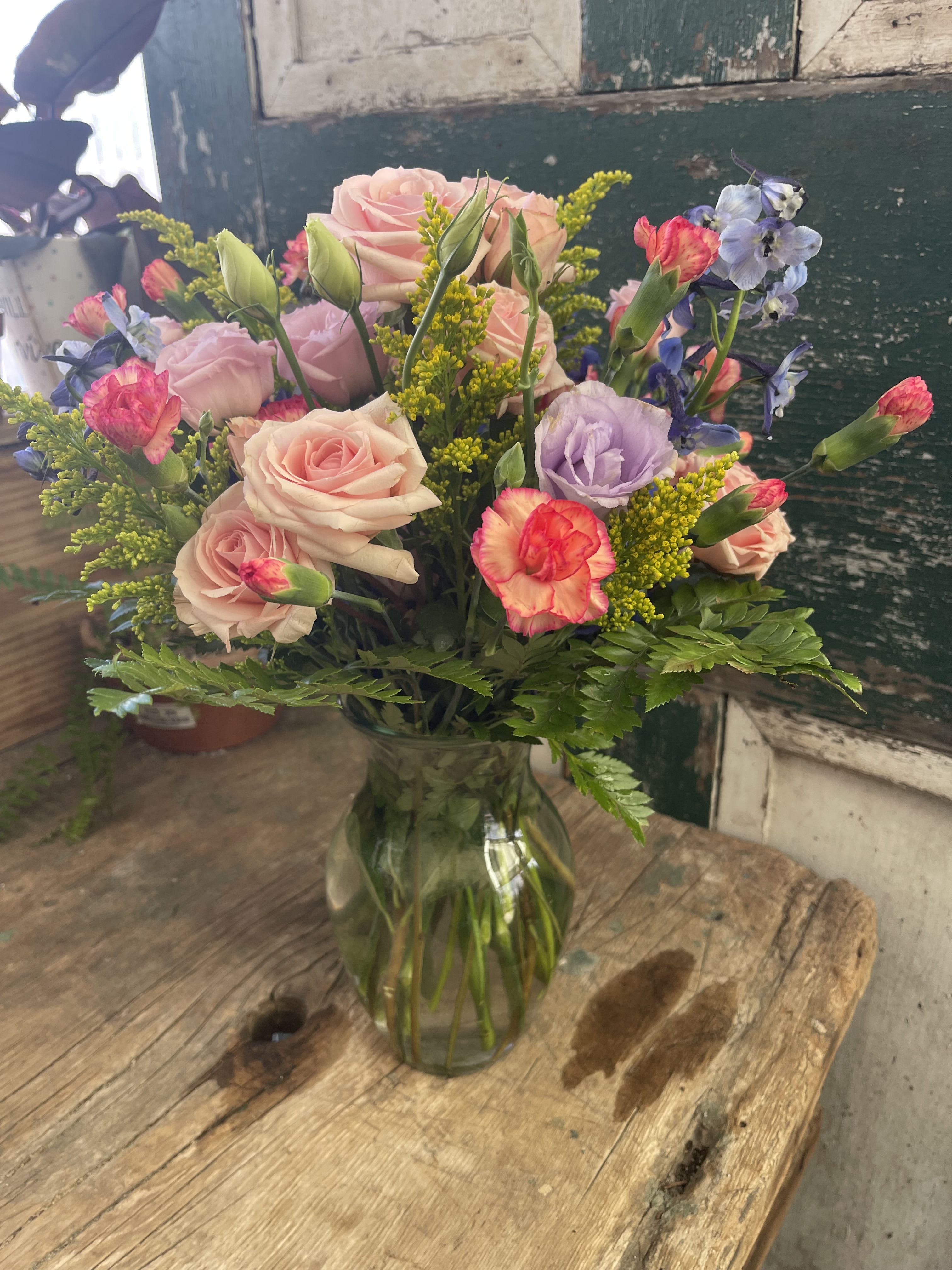 Timeless Beauty - Mix the timeless beauty of lipstick-hued spray roses and lisianthus with a few blue blossoms, and you’ll have this beautiful, blushing bouquet that’s as creative as the prettiest make-up palette. Colorful and sweet!