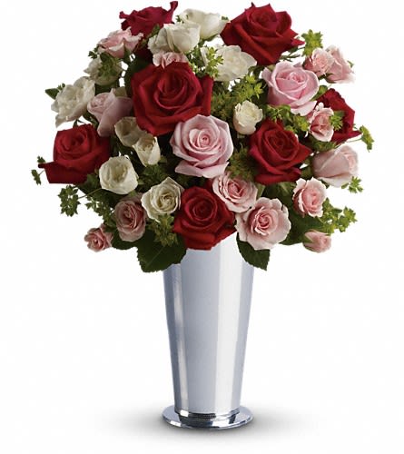 Bouquet of red, pink, and white roses in a silver vase