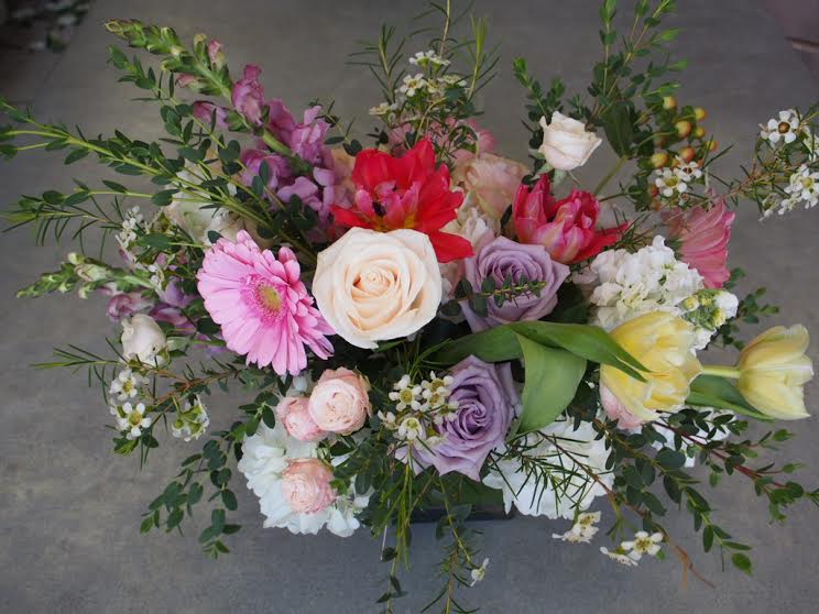 Mixed bouquet with roses, tulips, and gerbera daisies in pink, white, purple, and yellow