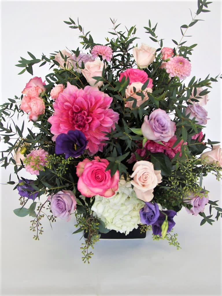 Gratitude - Pinks and purple arrangement in a clear cube vase. 