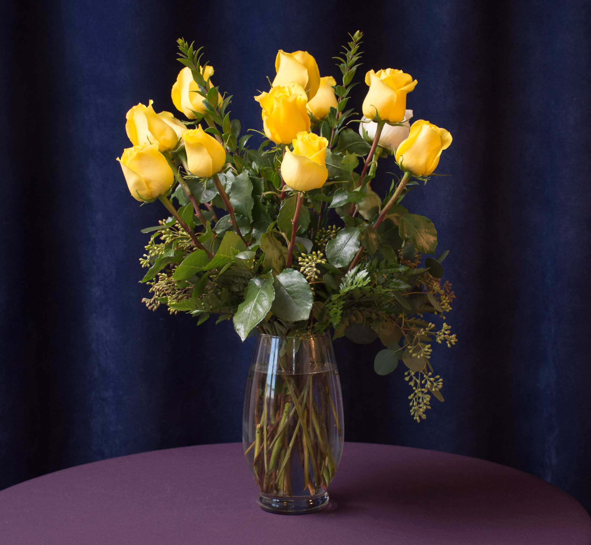 Forever Friends - 12 yellow roses arranged with several different types of greenery. 