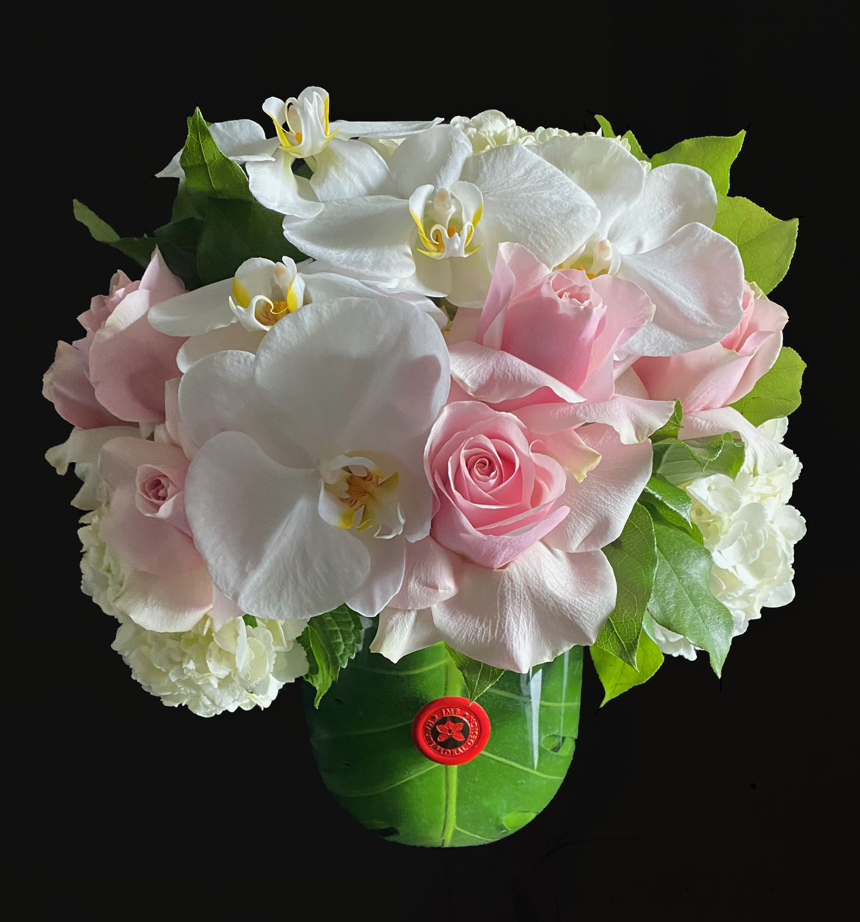 The Perfect Flowers - The perfect arrangement for any occasion, clean lines, orchids , hydrangeas and roses, in a taped leaf lined glass vase. One size available as pictured 6 in tapered glass vase.