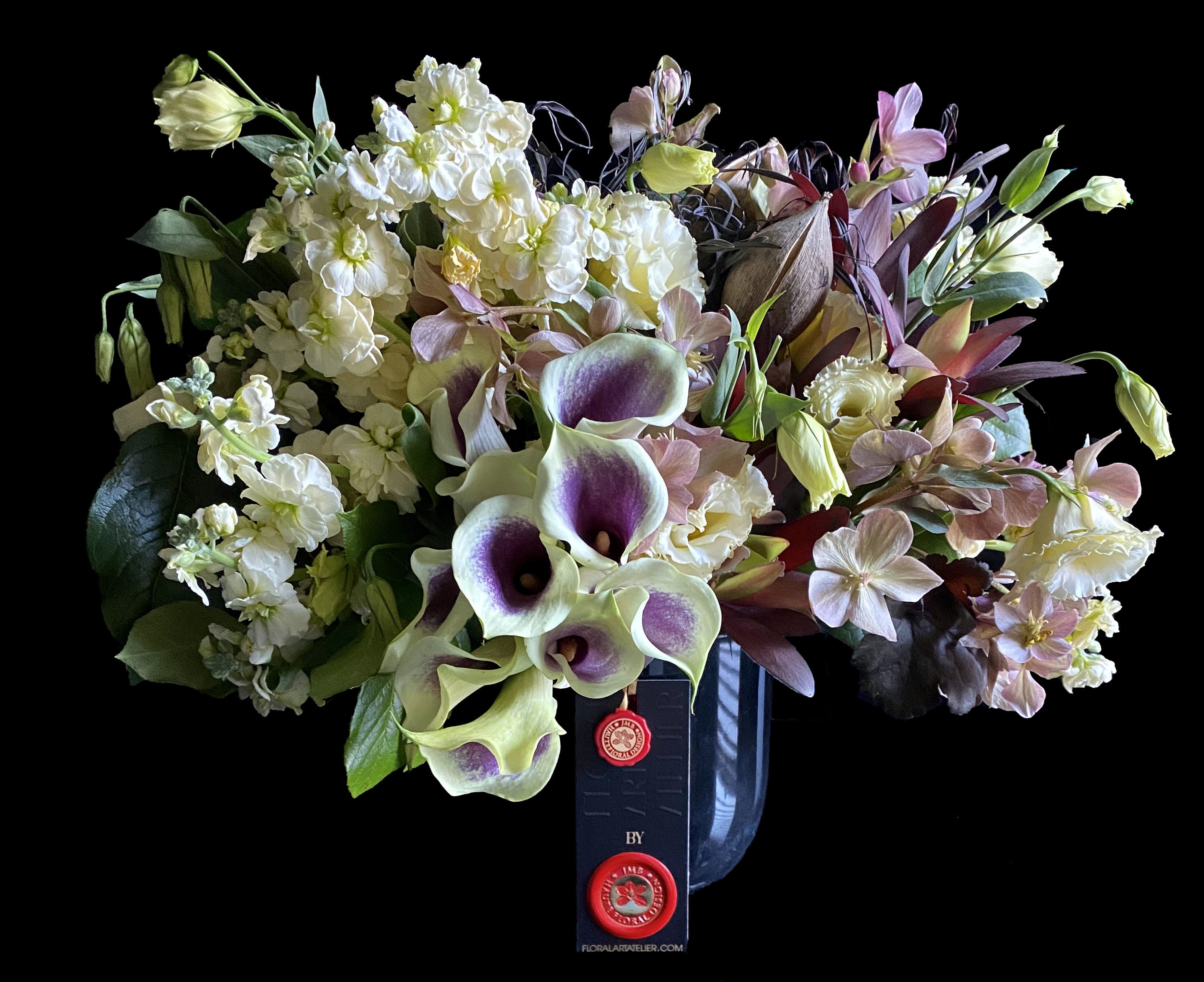 Bouquet of white and lavender flowers in a dark vase
