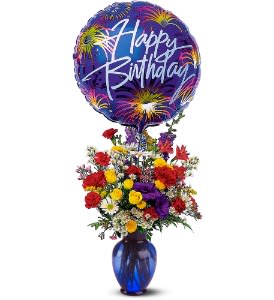 Birthday balloon above a colorful mixed flower arrangement in a blue vase
