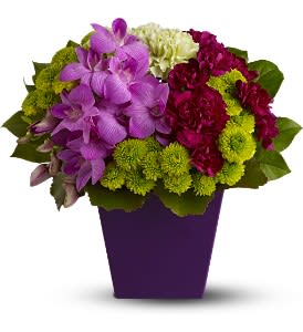 Purple and magenta flowers arranged in a purple vase
