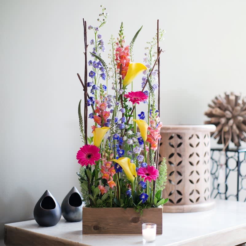 Tall mixed floral arrangement with yellow calla lilies and pink gerbera daisies