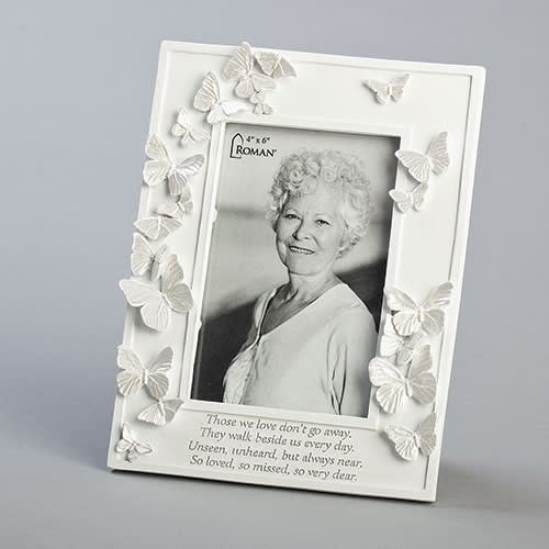 White memorial photo frame decorated with butterflies and a portrait inside