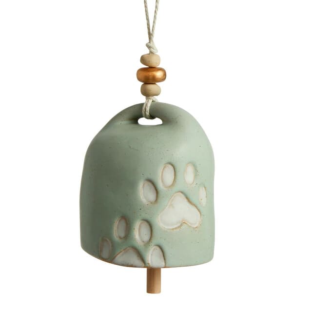 Ceramic hanging bell with paw print cutouts and a rope hanger
