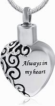 Heart-shaped silver pendant with black swirl design and text