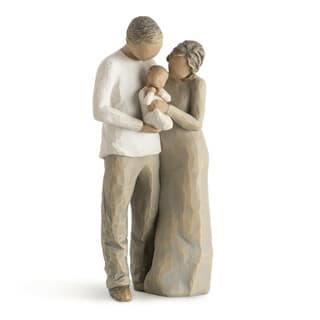 Wooden figurine of a couple holding a baby