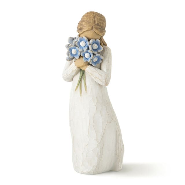 Figurine of a girl holding a bouquet of blue flowers