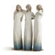 Three blurred figures in long white dresses standing together