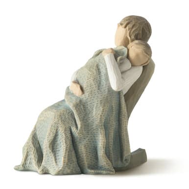 Wooden figurine of a seated woman holding a child