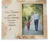 Blurred memorial card with a man and child walking on a path