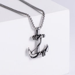 Silver anchor pendant necklace on a white box