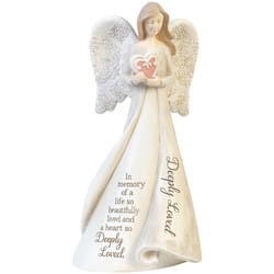 White angel figurine holding a pink heart with memorial text on the robe