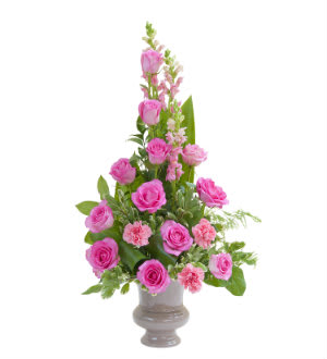 Pink roses and carnations arranged in a gray vase