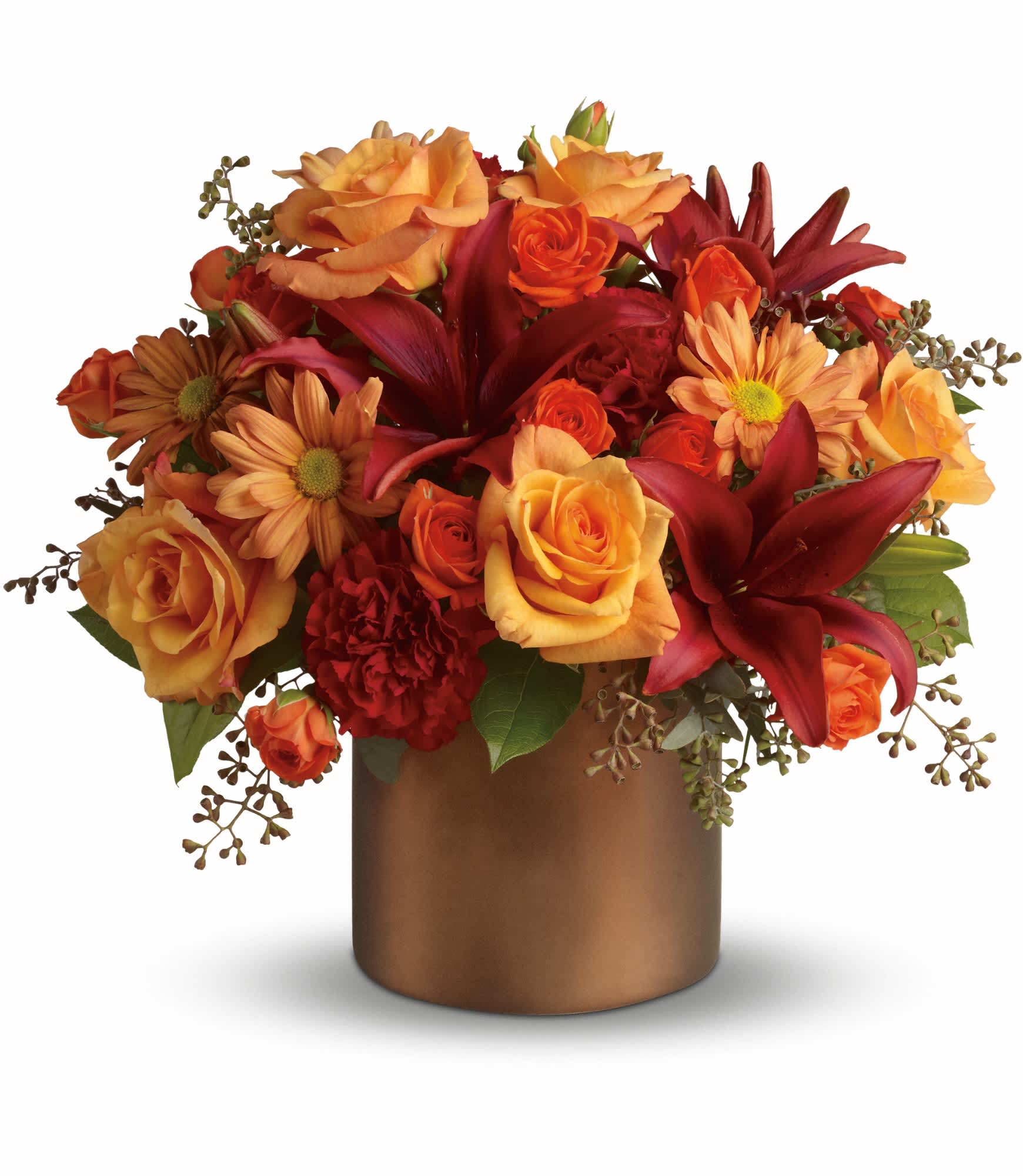 Orange and red flower arrangement in a bronze vase
