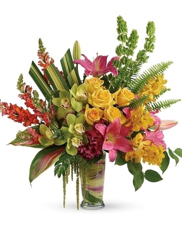 Tropical bouquet in a glass vase with pink lilies and yellow orchids