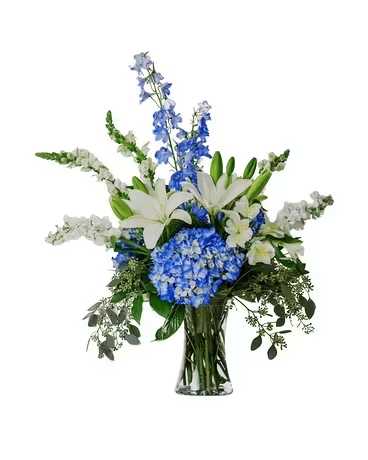 Blue and white floral arrangement in a clear glass vase