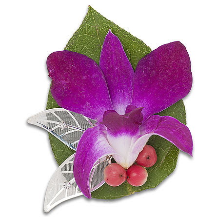 Purple orchid corsage with green leaves and silver accents