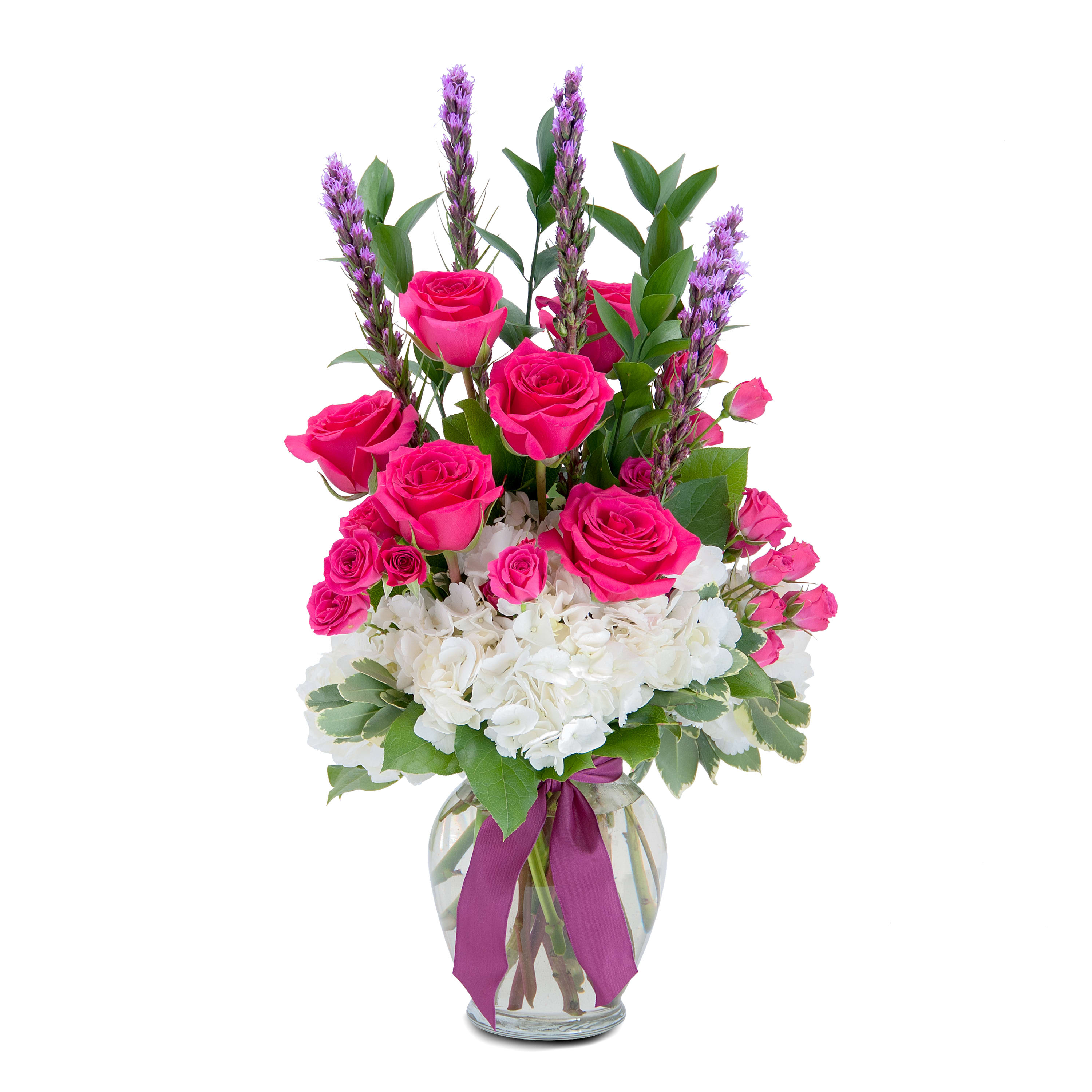 Genuine Love - A bright and bold combination of gorgeous hot pink roses and spray roses, white hydrangea, liatris and assorted foliage. Designed in a clear glass vase and finished with a ribbon tie. Remember your Motherâs genuine love with the gift of this beautiful arrangement.