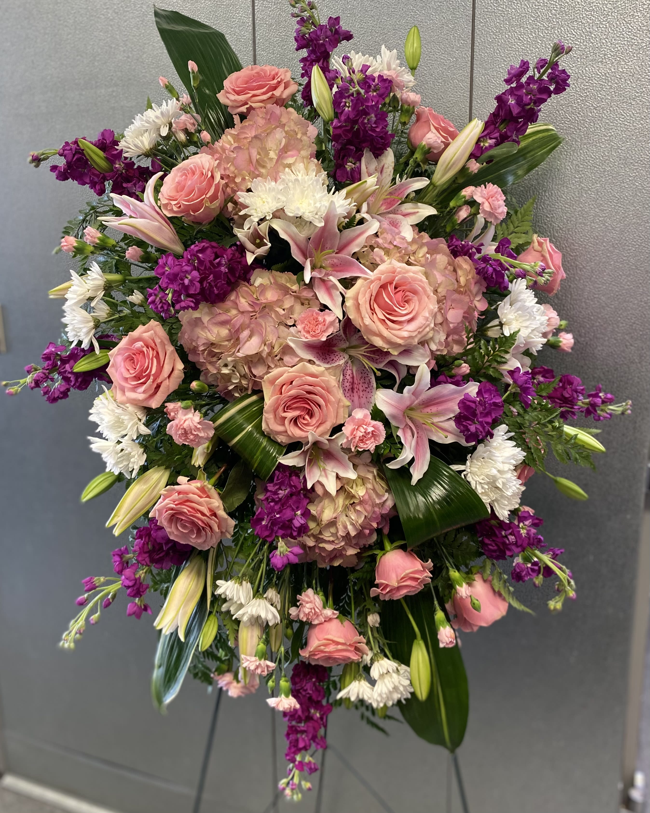 Large bouquet of pink roses, lilies, and purple flowers