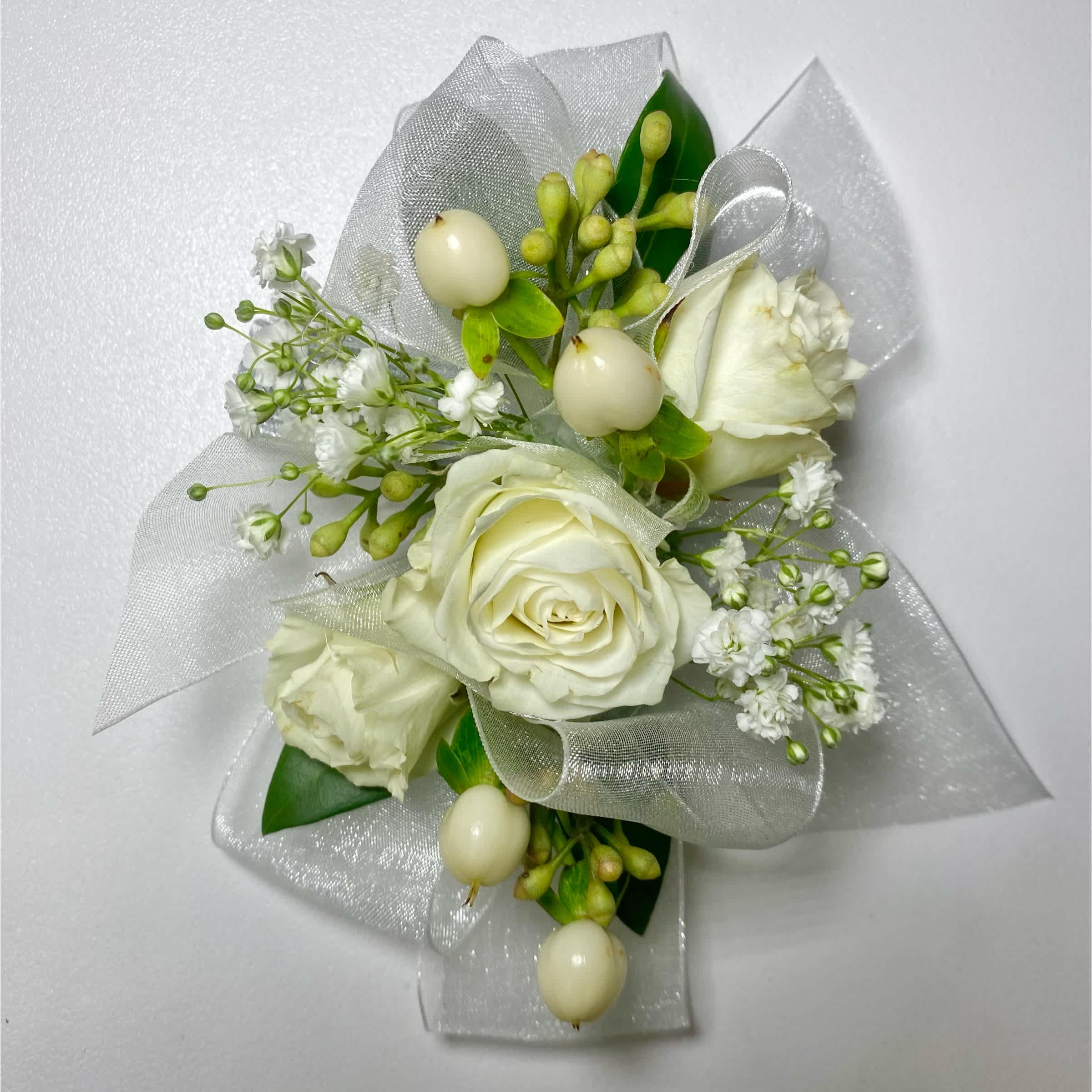White rose corsage with silver ribbon and small white filler flowers