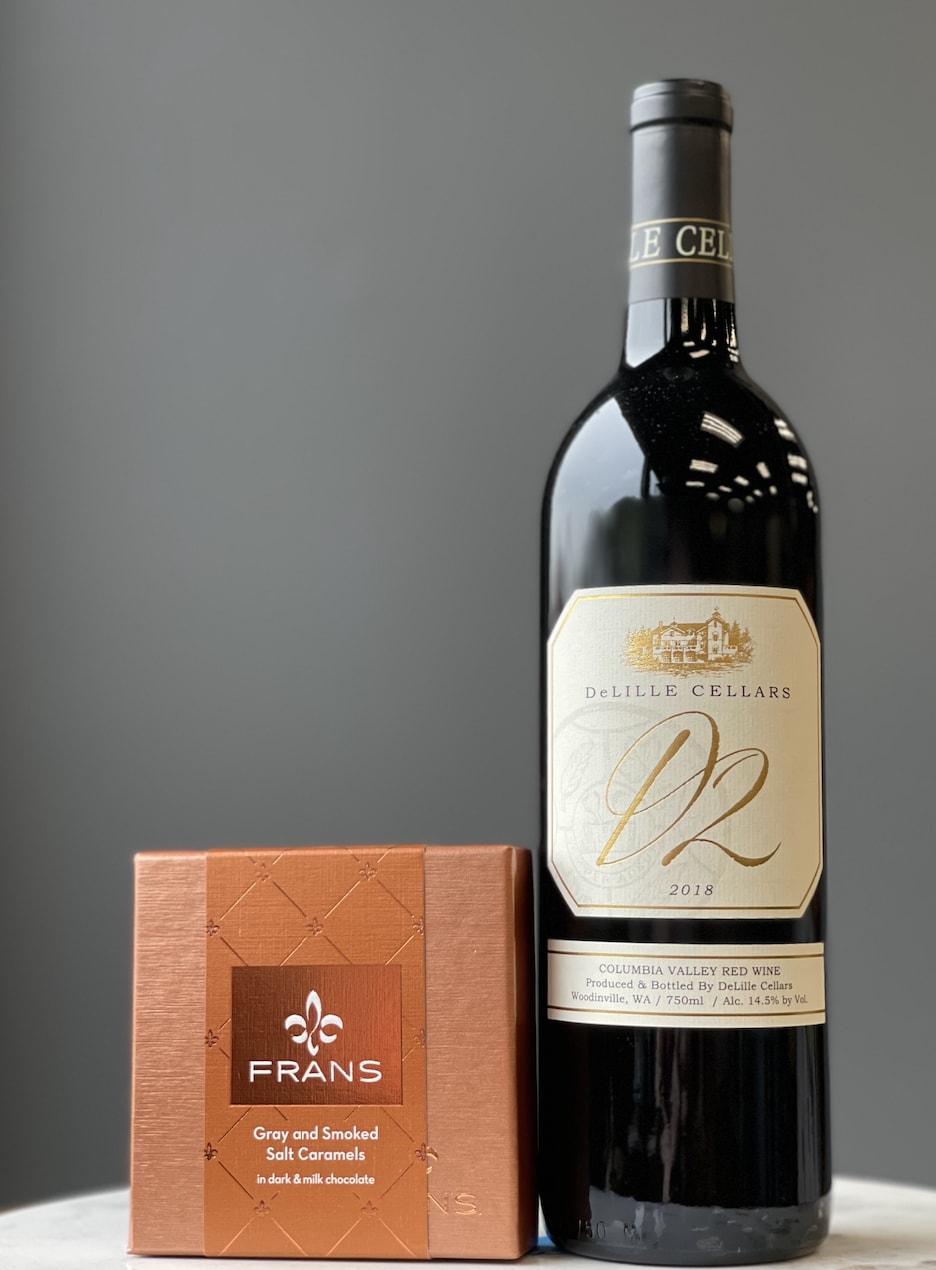 Wine bottle beside a box of gray and smoked salt caramels