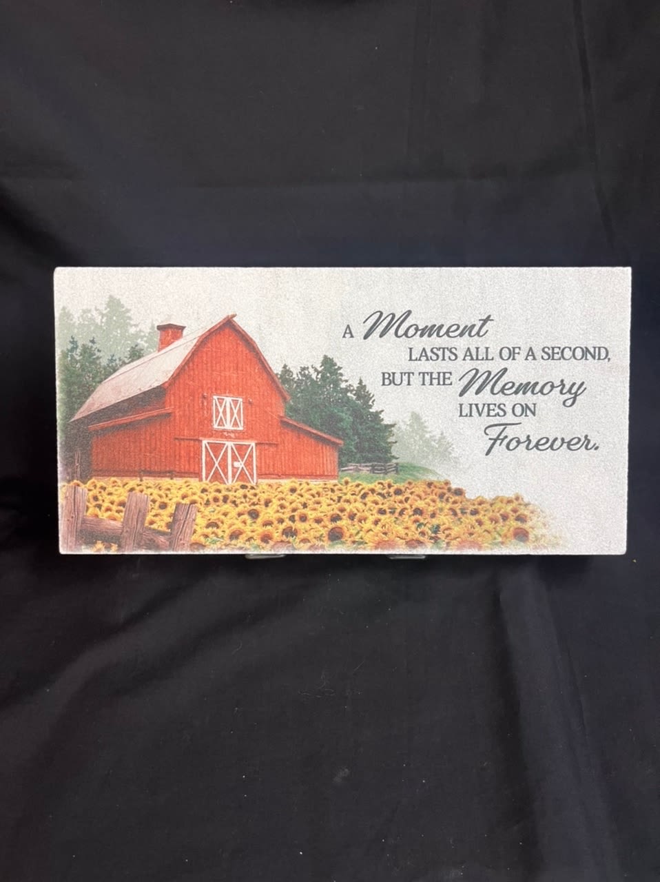 Memorial card with a red barn and a field of sunflowers