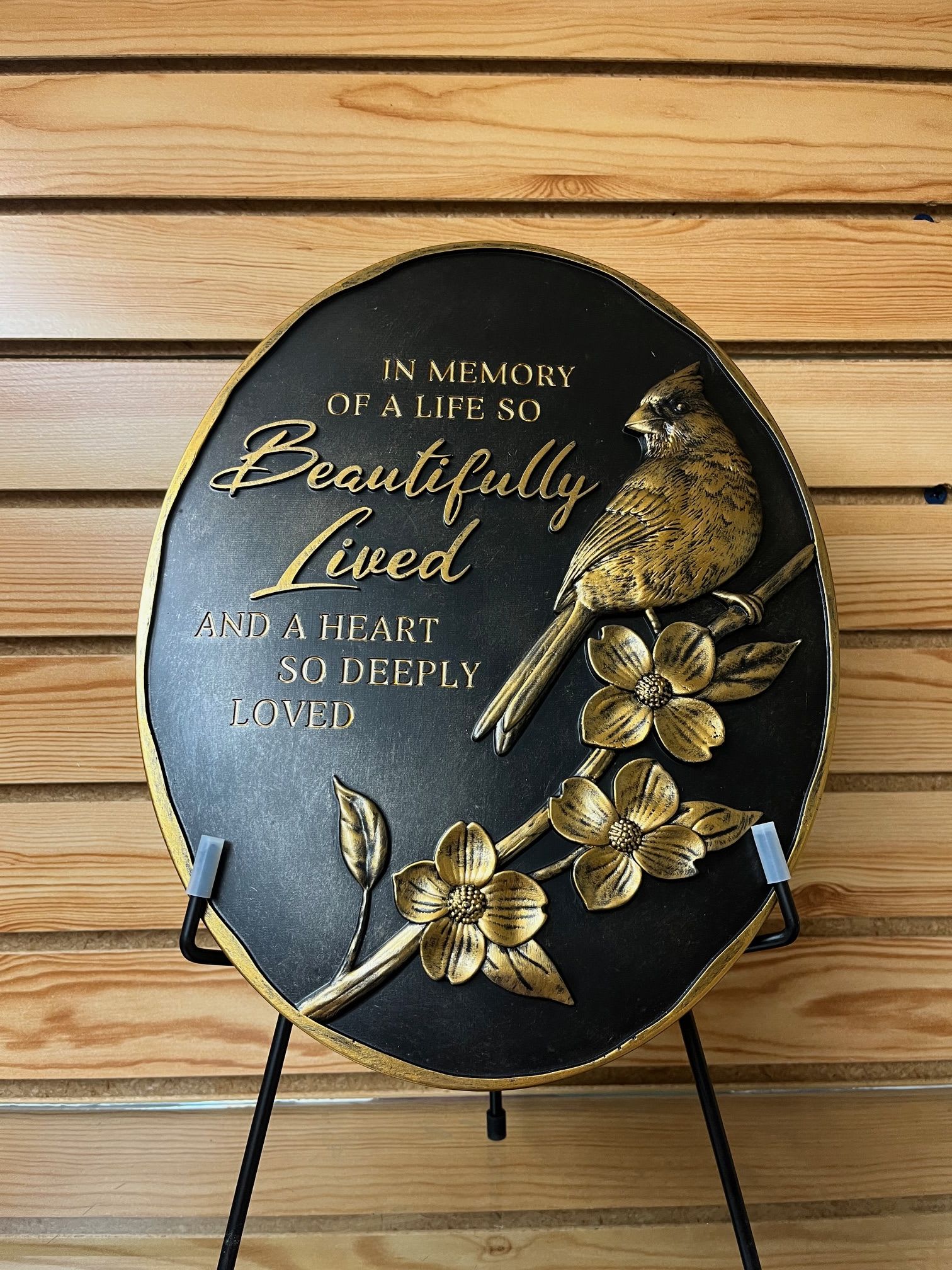 "Beautifully Lived" Golden Cardinal Stone with Easel - This black and golden stone features a cardinal and floral detailing with a commemorating phrase:  "In Memory of a Life so Beautifully Lived and a Heart So Deeply Loved"