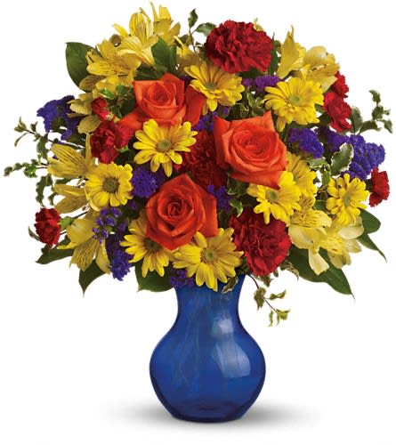 Mixed bouquet of roses, daisies, and carnations in a blue vase