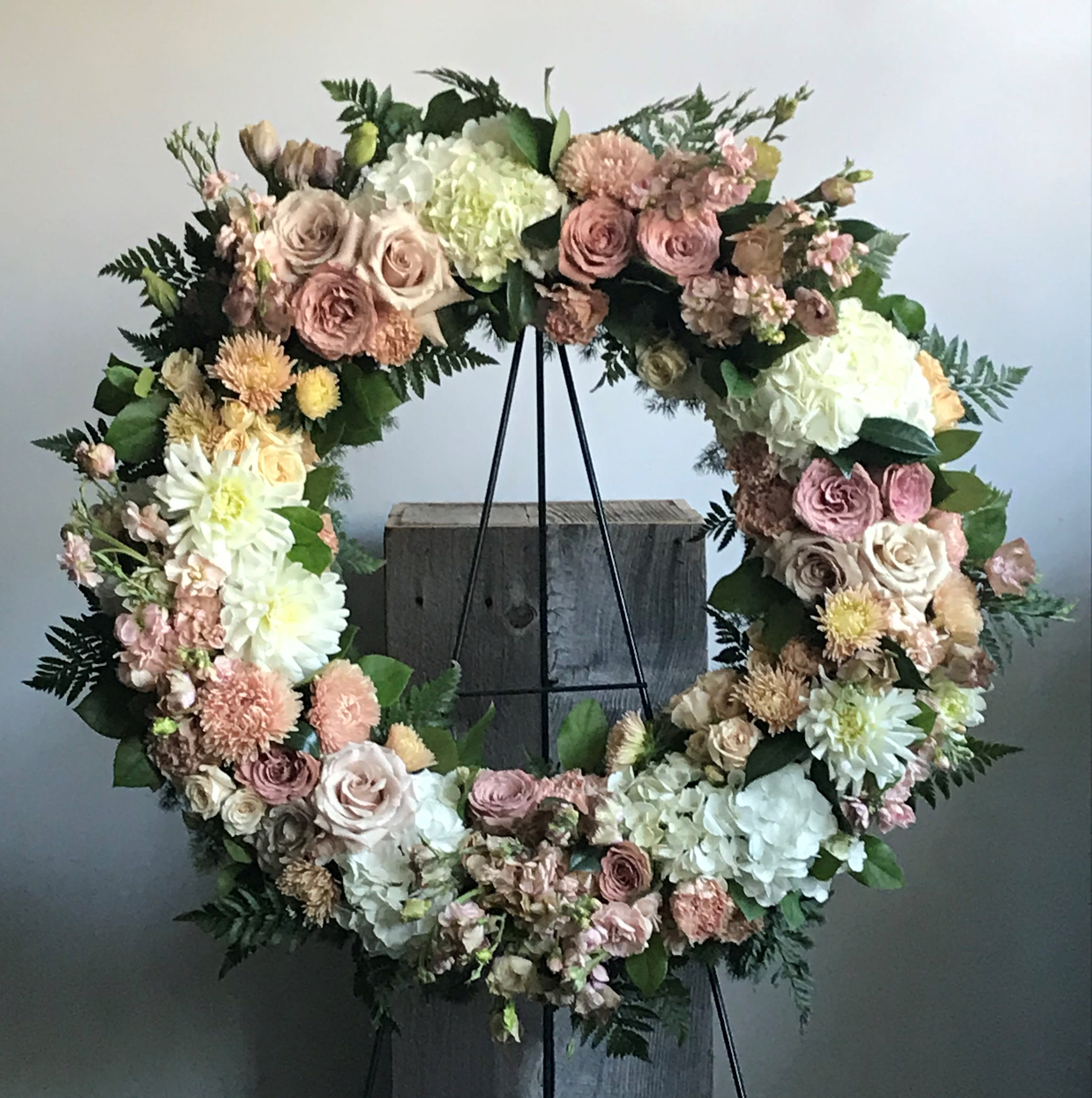 Sympathy Wreath - Soft &amp; Muted - A beautiful subtle palate of cream, blush, soft pink, peach and mauve consisting or roses, spray roses, mums, carnations, dahlias and other seasonal flowers and foliage. Wreath measures approximately 24" in diameter.  Please Note: Design may not look exactly like what is pictured. Will vary due to floral availability and artistic interpretation. 