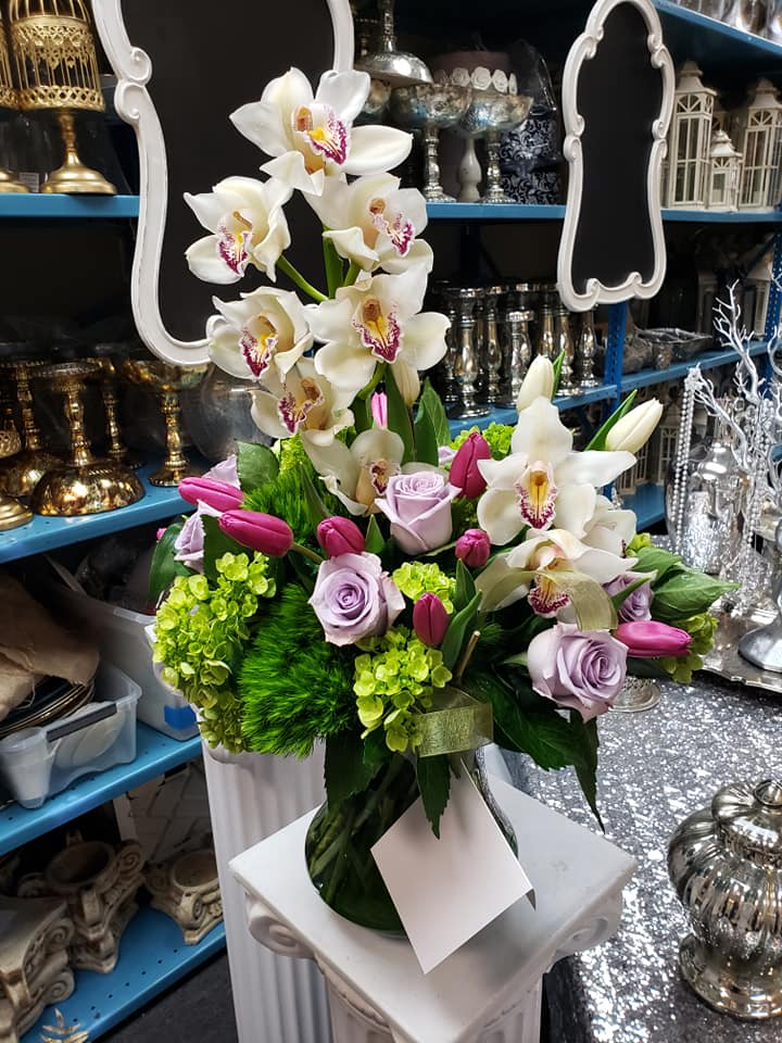 White orchids and lavender roses in a vase with pink tulips