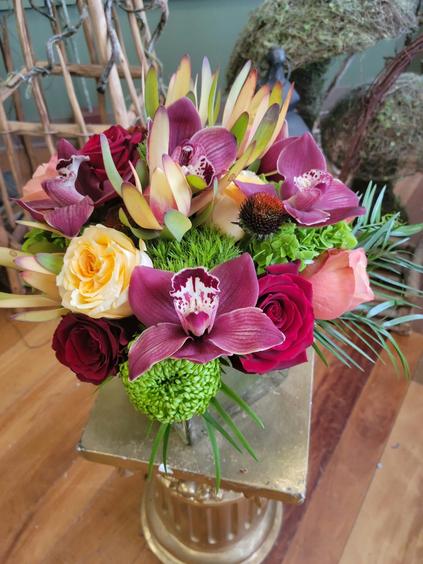 Mixed bouquet with orchids, roses, and green chrysanthemums in a vase