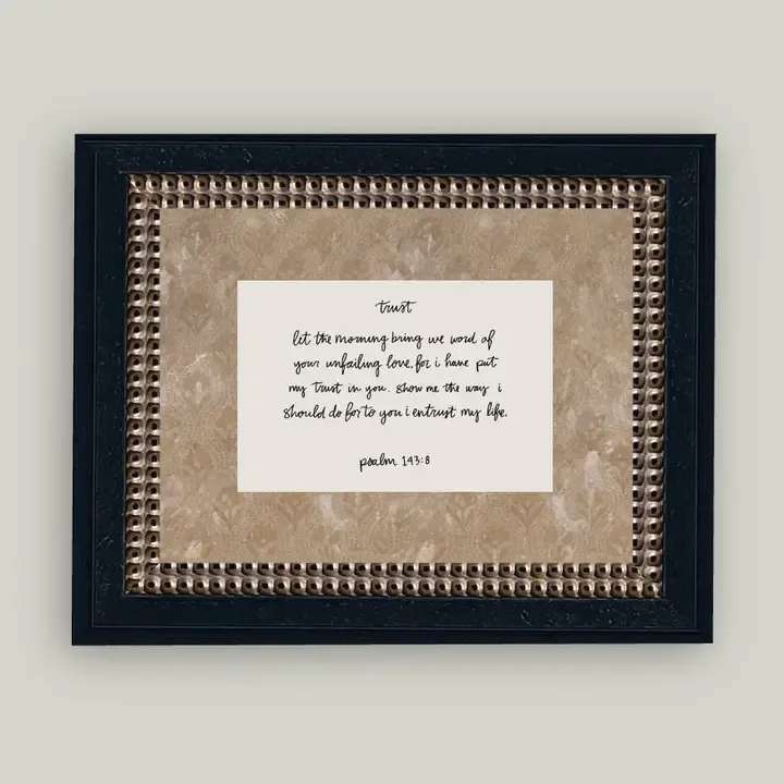 Framed wall art with a handwritten Bible verse on a beige background